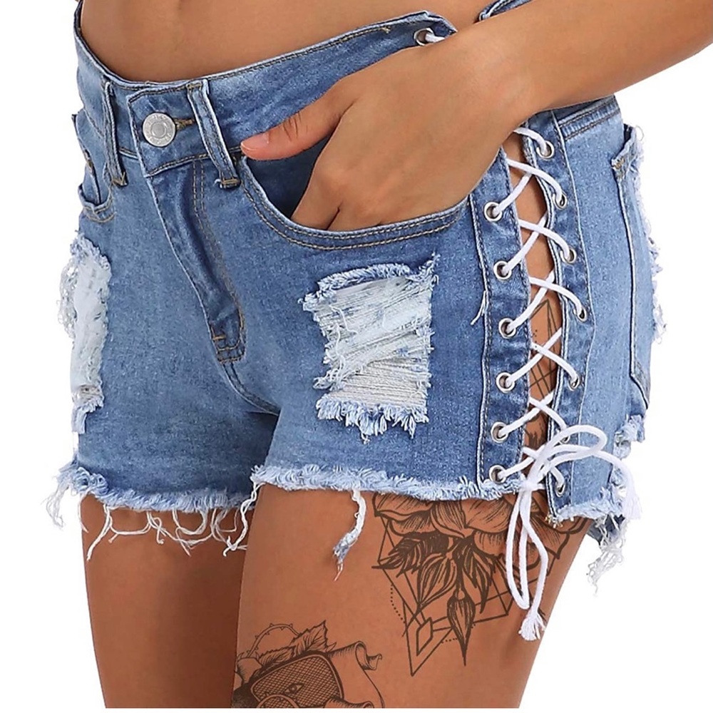 Ripped jean shorts with white cris cross ties. Size Small